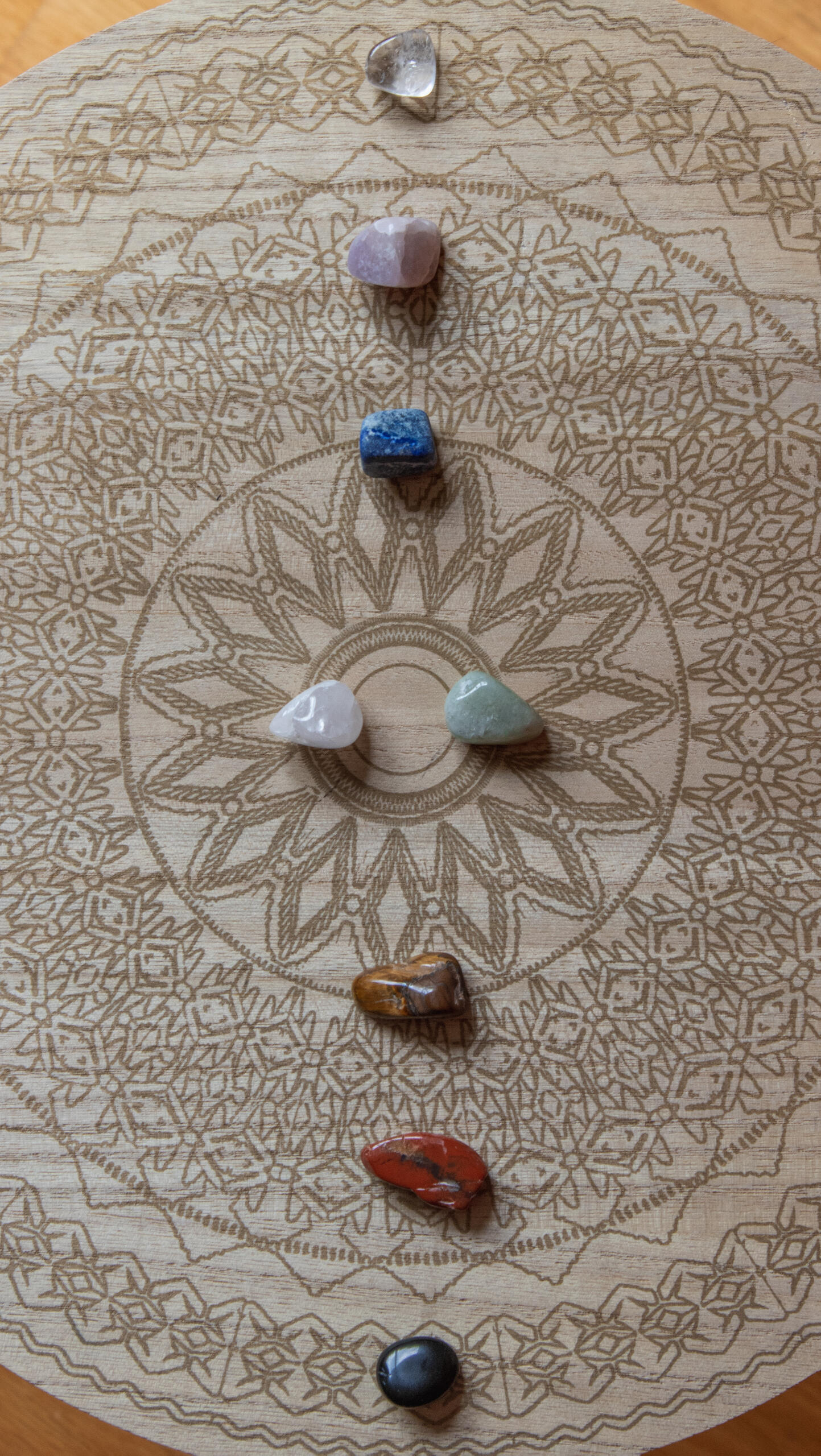Image of some crystal tumblestones on a brown fabric background